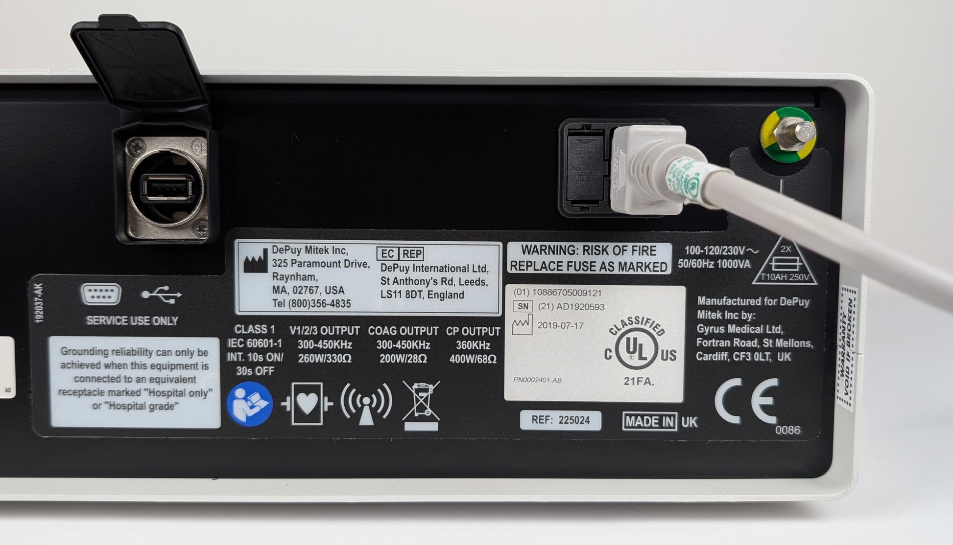 Back view of a power supply unit with labels and certification logos on a white background