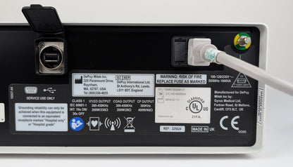 Back view of a power supply unit with labels and certification logos on a white background